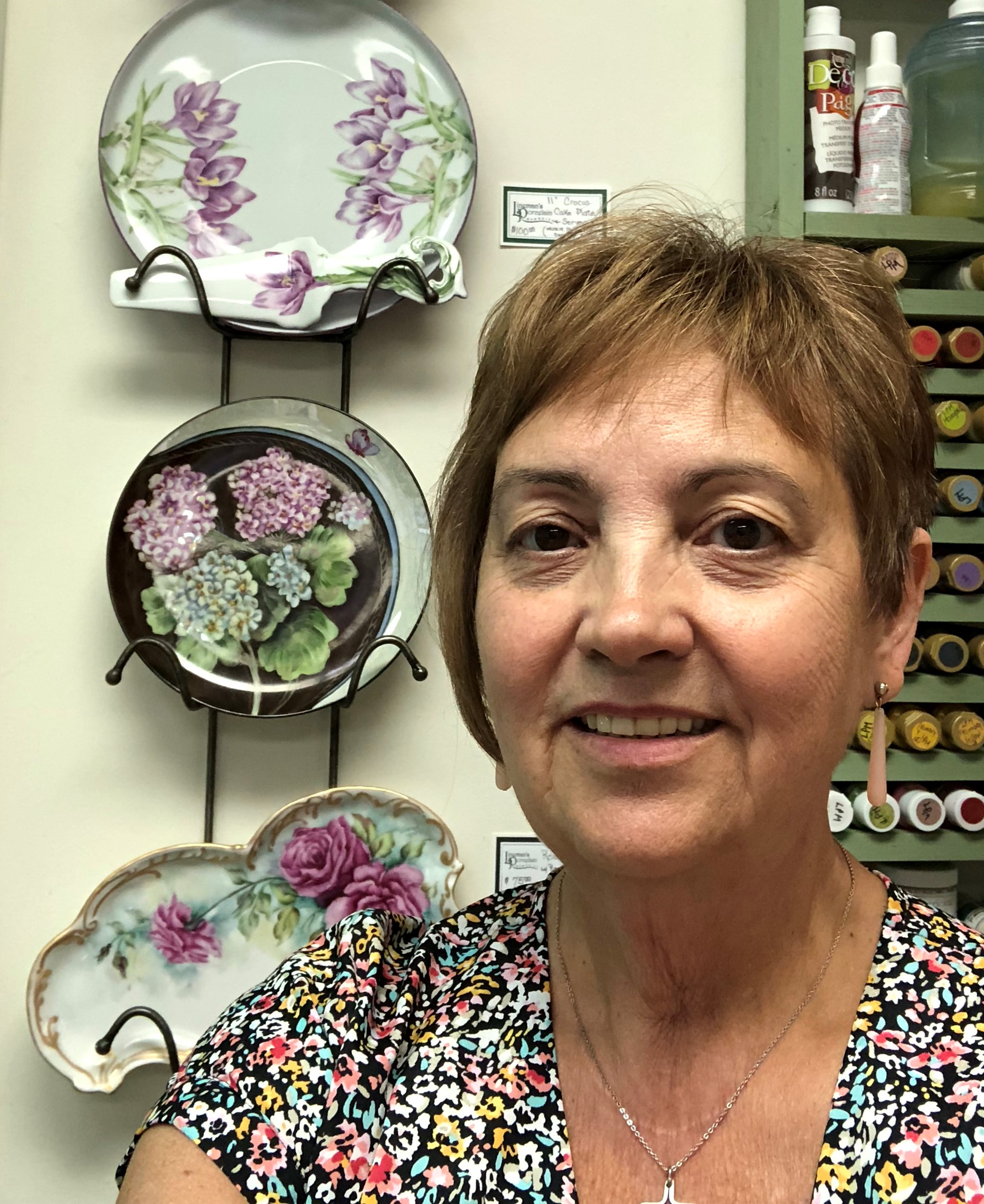 Linda in front of some of her porcelain artwork