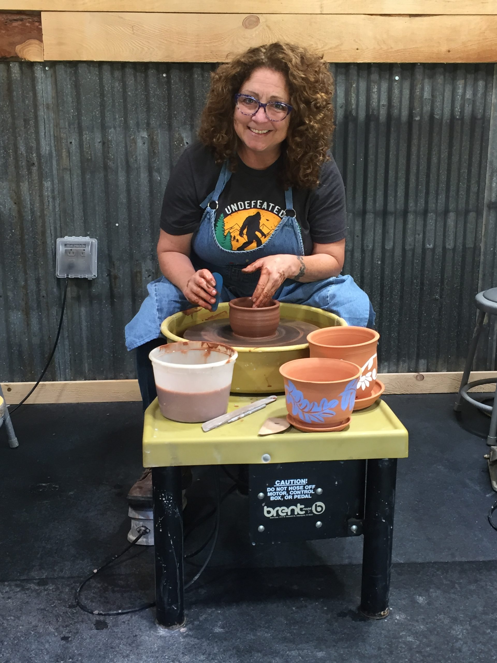 Cynthia creating at her potters wheel in her studio.